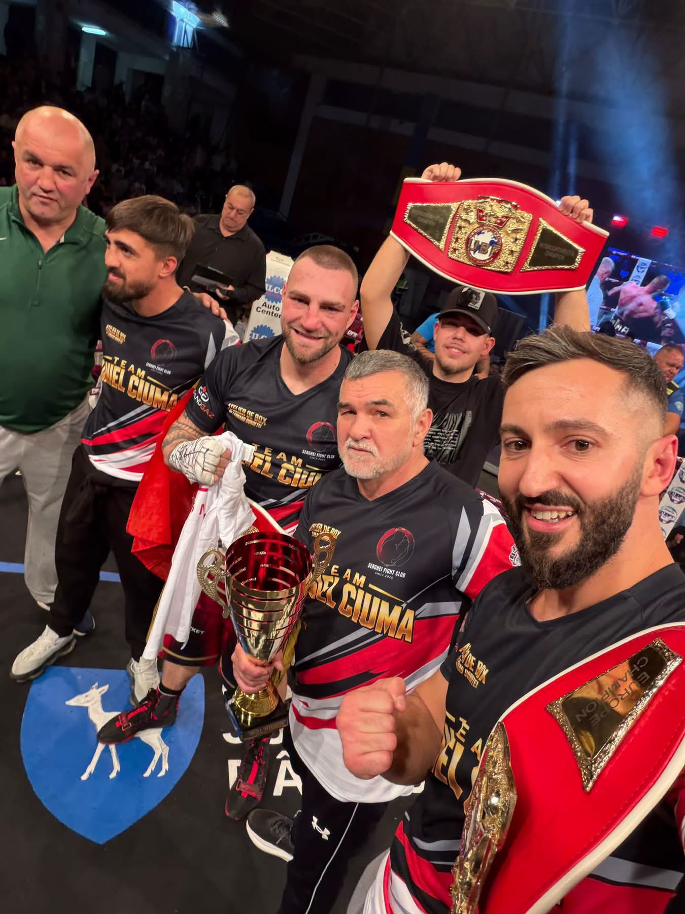 Ion Daniel Ciuma and his team celebrating with championship belts after his UBF world title victory