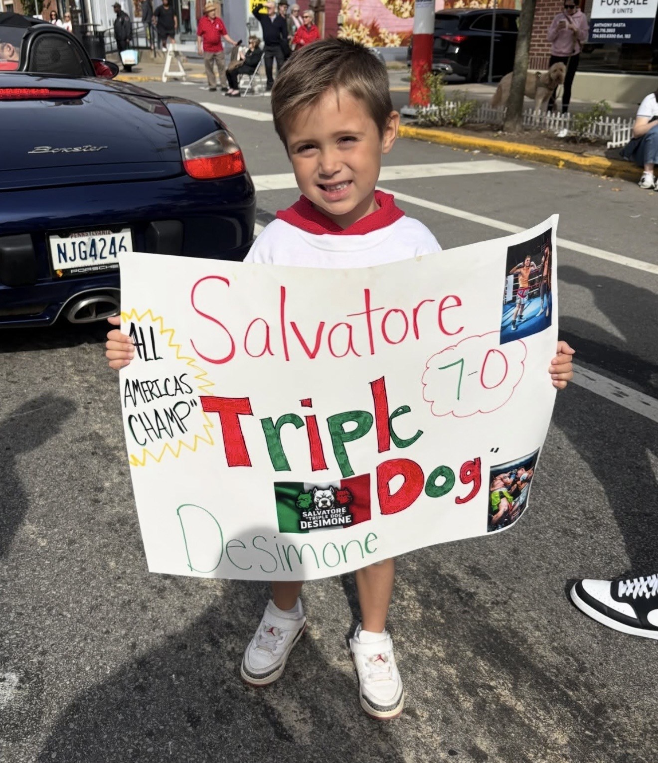 A young fan proudly displays a handmade tribute to DeSimone’s 7–0 record.