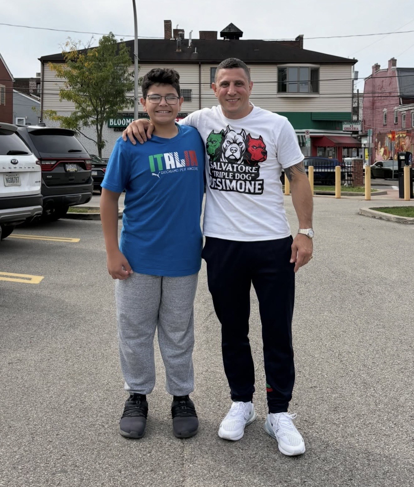 A supporter poses with a young fan in Pittsburgh’s Little Italy.